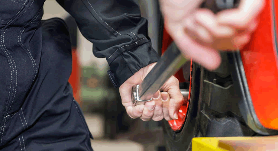 Workers are repairing wheels with torque wrenches Workers are repairing wheels with torque wrenches
