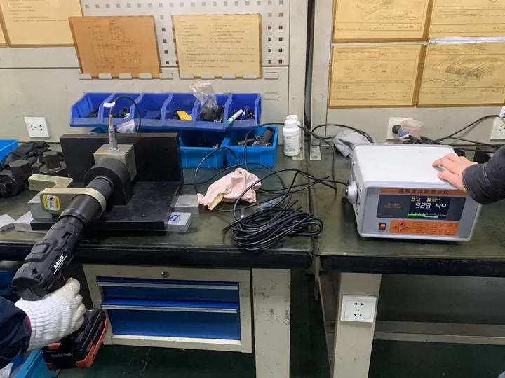 An electric torque wrench connected to a torque indicator An electric torque wrench connected to a torque indicator